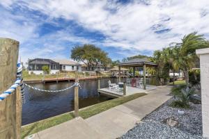 a marina with a dock and a house at Collinson Ct Retreat | Palm Coast in Palm Coast