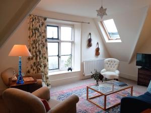 a living room with a couch and a table at Haslington House in Malvern Wells