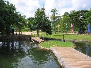a wooden walkway over a pond in a park at Camotes Resthouse in Camotes Islands