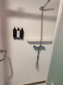 a bathroom with two bottles of soap on a shelf at Casa do Meio em Quinta de São Pedro de Vir-a-Corça in Monsanto