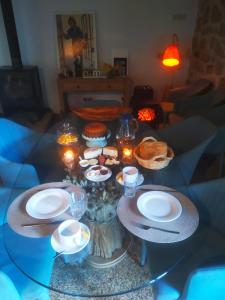 une table avec des assiettes et des verres dans l'établissement Casa do Meio em Quinta de São Pedro de Vir-a-Corça, à Monsanto