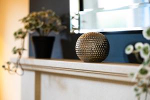 a gold container sitting on a counter with potted plants at Maxwell Gardens in Huntingdon