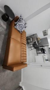 a couch with a watch on top of it at Aurora legal suite in Calgary