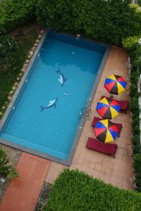 an overhead view of a swimming pool with umbrellas at The Right Resort in Pattaya Central