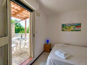 a room with a bed and a table and a window at Residence Mariposa - Apartments & Rooms in Salve +291 photos