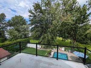 a view from the balcony of a house with a swimming pool at Riverview Cottage in Laval