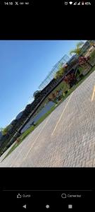 a picture of a brick road with a train on it at Parque monte alto Rio das ostras in Rio das Ostras