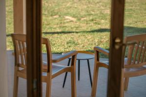 two chairs and a table on a porch at PARADAISE SUITES SEA VIEW SARDINIA, Bedda Ista in Castelsardo