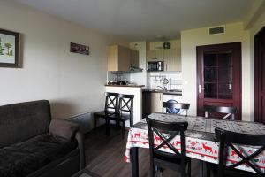 a living room and kitchen with a table and a couch at Résidence Serias - T3/6pers SERIAS 17- Peyresourde MAE-3524 in Germ