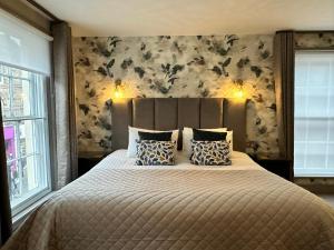 a bedroom with a large bed with two pillows at Goswell House in Windsor