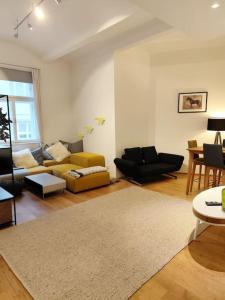 a living room with couches and a rug at Very cosy and quiet Apartment at Stadtpark in Vienna