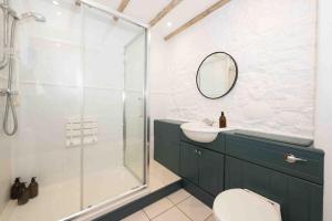 a bathroom with a shower and a sink and a mirror at Spacious country retreat in the heart of Devon. in Crediton