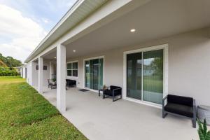 a porch of a house with chairs and windows at Modern 5BR Getaway, PS5 & Board Games - Port St. Lucie, Florida in Carlton