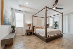a bedroom with a canopy bed in a room at Modern 5BR Getaway, PS5 & Board Games - Port St. Lucie, Florida in Carlton