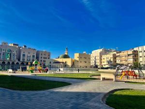 a city with a park with a playground and buildings at APT 202 5 Twin Beds in Sulţānah