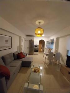 sala de estar con sofá y mesa en Veguita 2: piso renovado a 3 min de la playa, en Almería