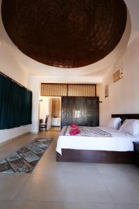 a bedroom with a large bed with a large ceiling at Sunshine Divers Club in Sharm El Sheikh