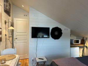 a room with a wall with a flat screen tv at Annas B&B in Järvsö