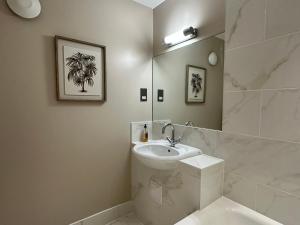 a white bathroom with a sink and a mirror at Goswell House Hotel central Windsor in Windsor +66 photos