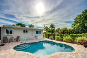 a swimming pool with a patio and a house at Lush Punta Gorda Escape Private Pool and Lanai in Punta Gorda