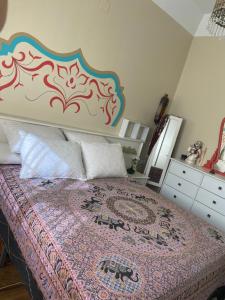 a bedroom with a large bed with a large headboard at Casa Cruz in Gelves