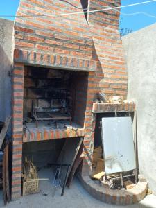 a brick oven with its door open with a mirror at Shanti in Esquel