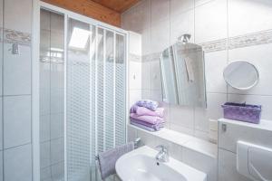 a white bathroom with a sink and a mirror at hausANNA - casaNAUTICO in Ueckermünde