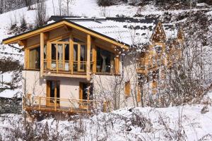 a house is being built in the snow at Chalet Des Domaines De La Vanoise - Confortable appartement au calme, à 1km du village et 5 km de la station MAE-3134 in Peisey-Nancroix +5 photos