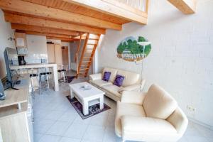 a living room with two white couches and a table at hausANNA - casaNAUTICO in Ueckermünde