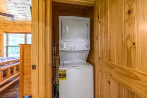 a washer and dryer sitting on top of a refrigerator at Misty Morning Meadow Breathtaking Smoky Mountain Cabin with Hot Tub, Views, & Free Tickets in Cosby +28 photos