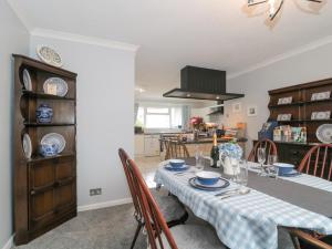 a kitchen and dining room with a table and chairs at Melita in Langport