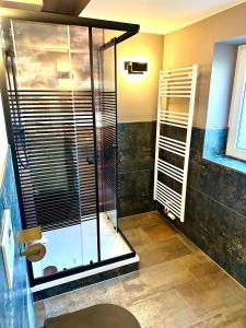 a bathroom with a shower with a glass door at Pension Victoria in Halberstadt