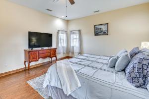 a bedroom with a large bed and a flat screen tv at Smithfield Vacation Rental about 5 Mi to Lake Jericho! in La Grange