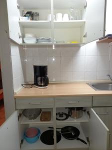 a kitchen with white cabinets and a counter with pots and pans at Ap22 Nature Ardennes Economy class apartment in La Calamine