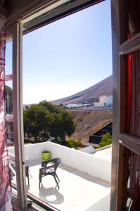 a view from the balcony of a house with a table and chairs at CASA RURAL GA7COLORES only adult in Montaña Blanca