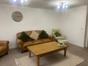 a living room with a couch and a coffee table at Shepshed 2 Bedroom Apartment in Shepshed