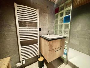 a bathroom with a sink and a wooden door at Résidence Le Cristal - Chalets pour 8 Personnes 154 in Crest-Voland