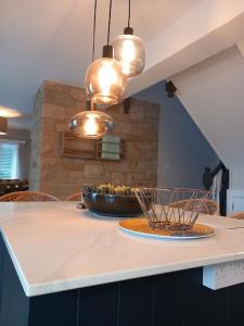 a kitchen with a table with a bowl on a counter at Beautiful Historic Cottage in Callander
