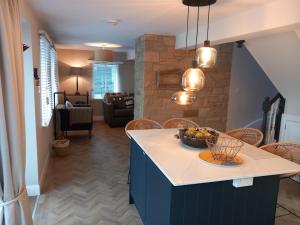 a kitchen with a island with a bowl of fruit on it at Beautiful Historic Cottage in Callander