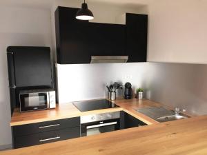 a kitchen with a microwave and a stove top oven at Appartement d'une chambre a Le Havre a 850 m de la plage in Le Havre
