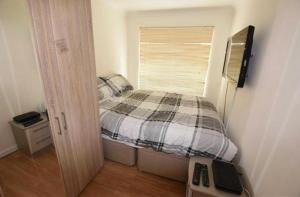 a small bedroom with a bed and a window at 8 Warren close Stanford-Le-Hope in Stanford-le-Hope