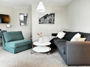 a living room with a couch and two chairs at Haus Gitta II in Luckenwalde
