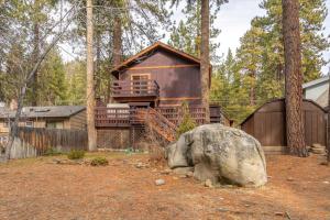 a cabin in the woods with a large rock at Cozy Pet-Friendly Cabin Hot-Tub Walk to Lake Tahoe Beach in Kings Beach