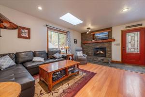 a living room with a couch and a fireplace at Cozy Pet-Friendly Cabin Hot-Tub Walk to Lake Tahoe Beach in Kings Beach