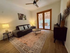 a living room with a couch and a table at Casa Kaan Calakmul in Xpujil