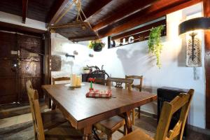 a dining room with a wooden table and chairs at 5 bedrooms chalet with wifi at Firgas in Firgas