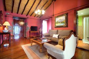a living room with a couch and a table at 5 bedrooms chalet with wifi at Firgas in Firgas