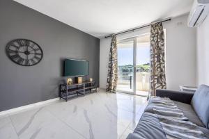 a living room with a couch and a tv at Sunset Bliss Luxury Apartment in St. Paul's Bay