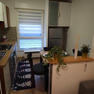 a small kitchen with a table and a window at Apartman Dory in Zagreb +14 photos