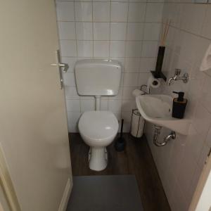 a small bathroom with a toilet and a sink at Apartman Dory in Zagreb